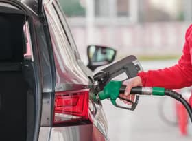 Close-up of a Person Refueling the Car at a Gas Station