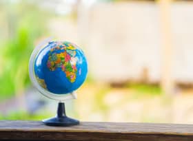 Colorful world globe on wooden surface