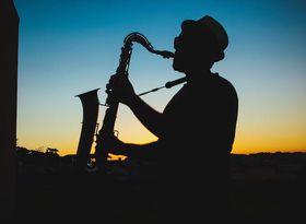 Silhouette of a Man Playing Saxophone during Sunset