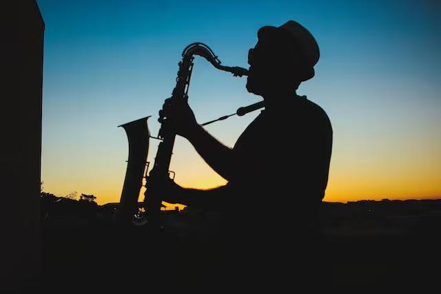 Silhouette of a Man Playing Saxophone during Sunset