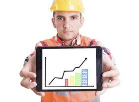 wp-Modern builder holding tablet with growing charts